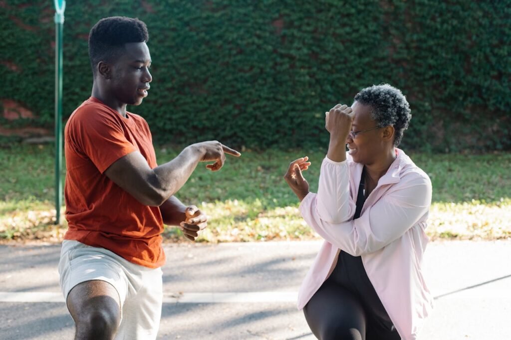 Two people enjoying an energetic workout session outdoors, embracing fitness and togetherness.